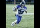 At right, Carter Holman sprinted up the field for a big gain against the Tigers.