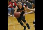 Eighth grader Zoe Hillmer looked to split a pair of B-H defenders. The guard contributed six points off the bench for the Tigers.