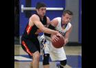 Bryce Irsfeld (L) battled with Waseca’s Nick Dufault (R) for control of the ball. The pair got locked in a duel with Dufault scoring a game high 36 and Irsfeld bringing his Tigers back into the game with a 32-point performance.
