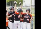 Taylor Hamilton (L), Alexis Cuchna (R), and the rest of the Tigers met Kenzi Riedel (4) at home plate after the first of her two home runs last Tuesday.