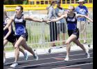 Elle Olson (L) took the handoff from fellow senior Claire Liebsch (R) during the state qualifying 4x200 relay race.