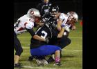 Kevin Escobar (13) and Dain Holmquist (55) teamed up to take down an Osakis ball carrier.