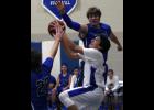 Luke Gustafson went up for a first half layup against a defending Charlie Kurowski (L) and Bennett Primus (R).