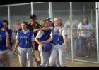 From left: Kayla Bense, assistant coach Steve Christians, Rachel Middendorf, Ally Ecker, and Emma Liebsch celebrate after Middendorf’s game winning hit.
