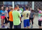 New head coach Chris Bemboom talked to his runners about weekend training as he wrapped up practice last Friday morning.