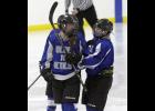 Abby Ecker (L) and Kenzie Christianson (R) celebrate after Ecker’s third period goal against Morris/Benson last Thursday.