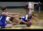Swanville’s Ellie Koetter (L) and Brooklyn Thieschafer (R) battled with Upsala’s Kiley Smieja (M) for a loose ball near mid-court.