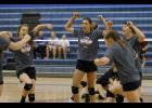 The Cardinals celebrate after scoring a point during the conference scrimmage last Tuesday. This year’s squad will look to rebuild under new head coach Reba Leither.