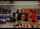 Quinn Kircher (L), Jenna Kunerth (M) and Allison Asfeld (R) celebrate after scoring a point during last Friday’s match with Swanville.