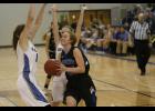 LPGE junior Rachel Middendorf (R) drove to the basket against Swanville’s Avery Jackson (L) and Madison Beseman (B). She finished with a season high 18 points in the win.