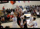 Tiger junior Jordan Gorder (M) attacked the rim against LPGE big men Eric Hinnenkamp (L) and John Towner (R). Gorder scored the first 11 points of the second half and finished with 15 points in the conference win.