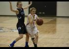 Upsala sophomore Jenna Ripplinger (R) drove to the hoop with LPGE senior Clarie Liebsch (L) defending her during last Tuesday’s game.