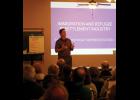 Ron Branstner addresses a near capacity crowd at the Hub Supper Club on the issues surrounding refugee resettlement.