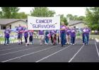 Cancer survivors make an honorary lap around the track during a recent Long Prairie Area Relay for Life.